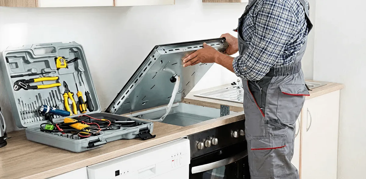 Handyman repairing a cooktop and checking wiring connections in Miami, FL