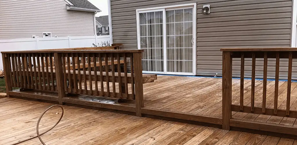 Deck sealing service protecting a backyard wood deck and railings in Miami, FL