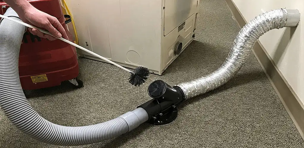 Dryer vent cleaning service removing lint from a dryer duct connection in Miami, FL