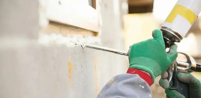 Handyman sealing exterior gaps with caulk for weatherproofing in Miami, FL