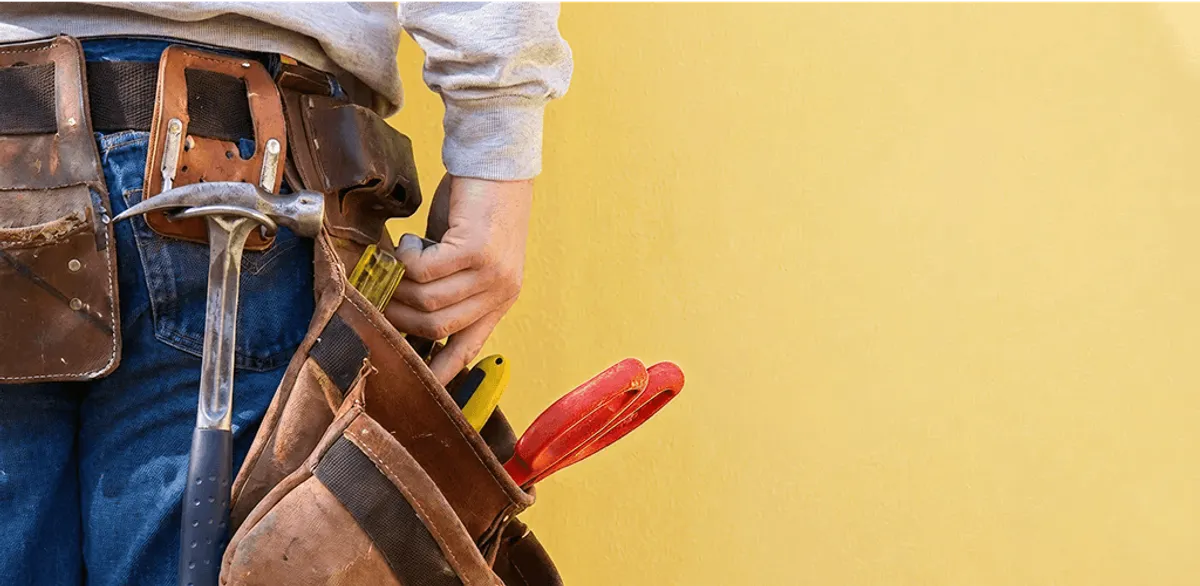 Handyman with tool belt ready for home repairs and maintenance in Miami, FL