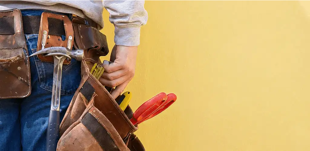 Handyman with tool belt ready for home repairs and maintenance in Miami, FL