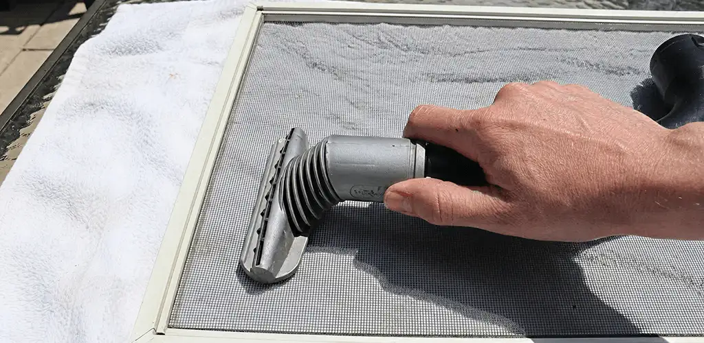 Window screen repair cleaning and fixing a damaged screen mesh in Miami, FL